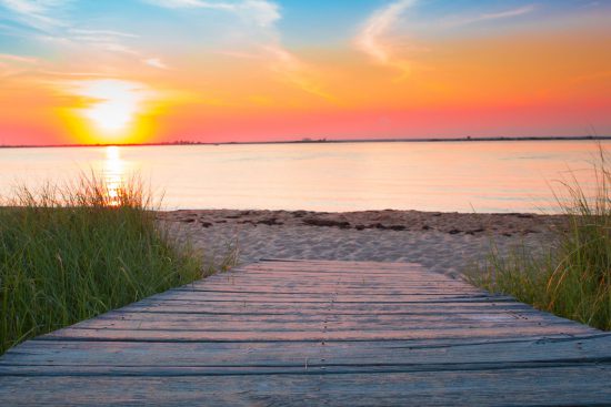 Pathway to a beach at sunset, symbolizing the future of vacation travel