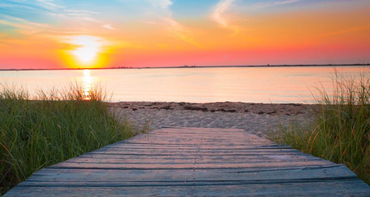 Pathway to a beach at sunset, symbolizing the future of vacation travel