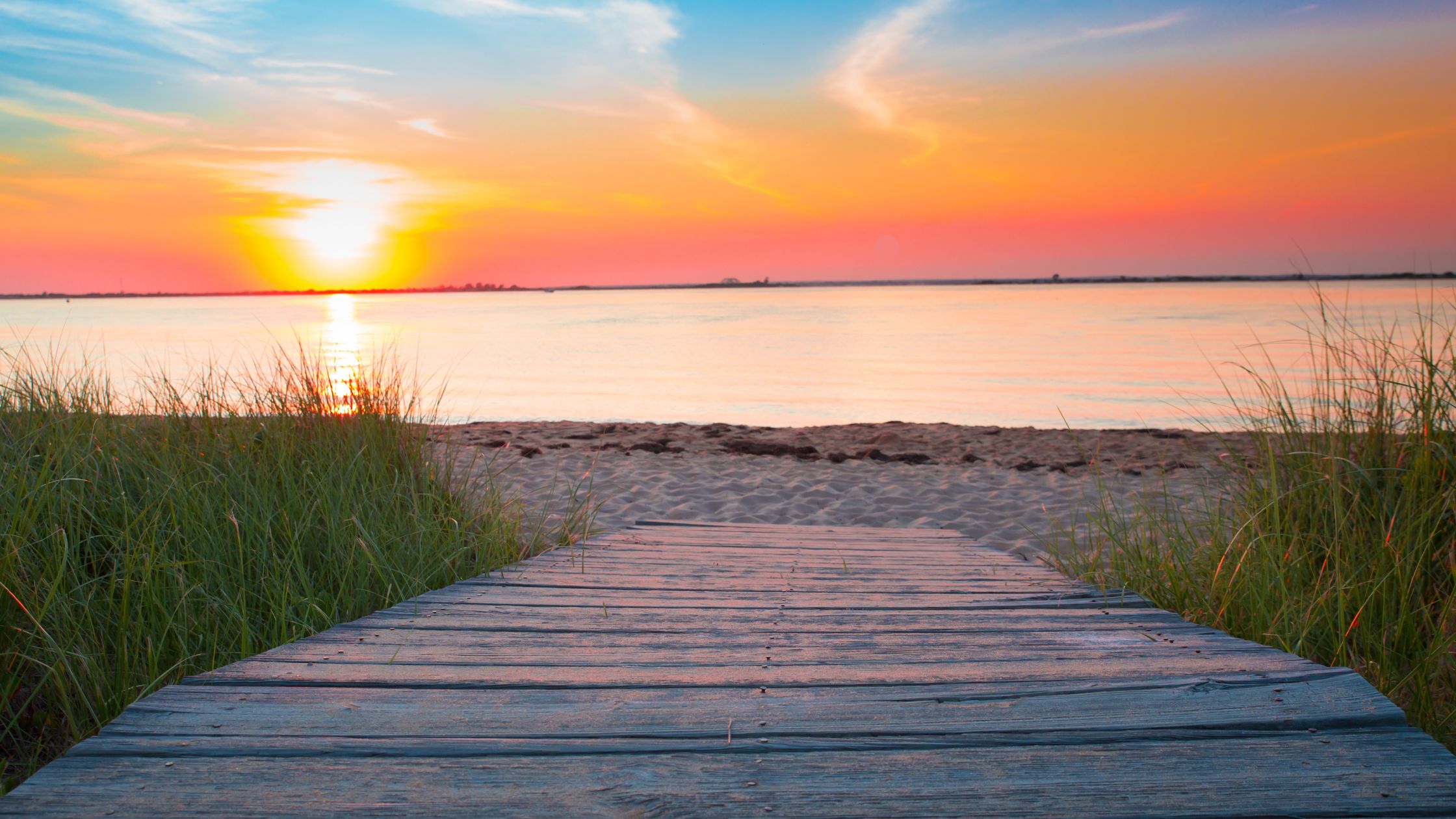 Pathway to a beach at sunset, symbolizing the future of vacation travel